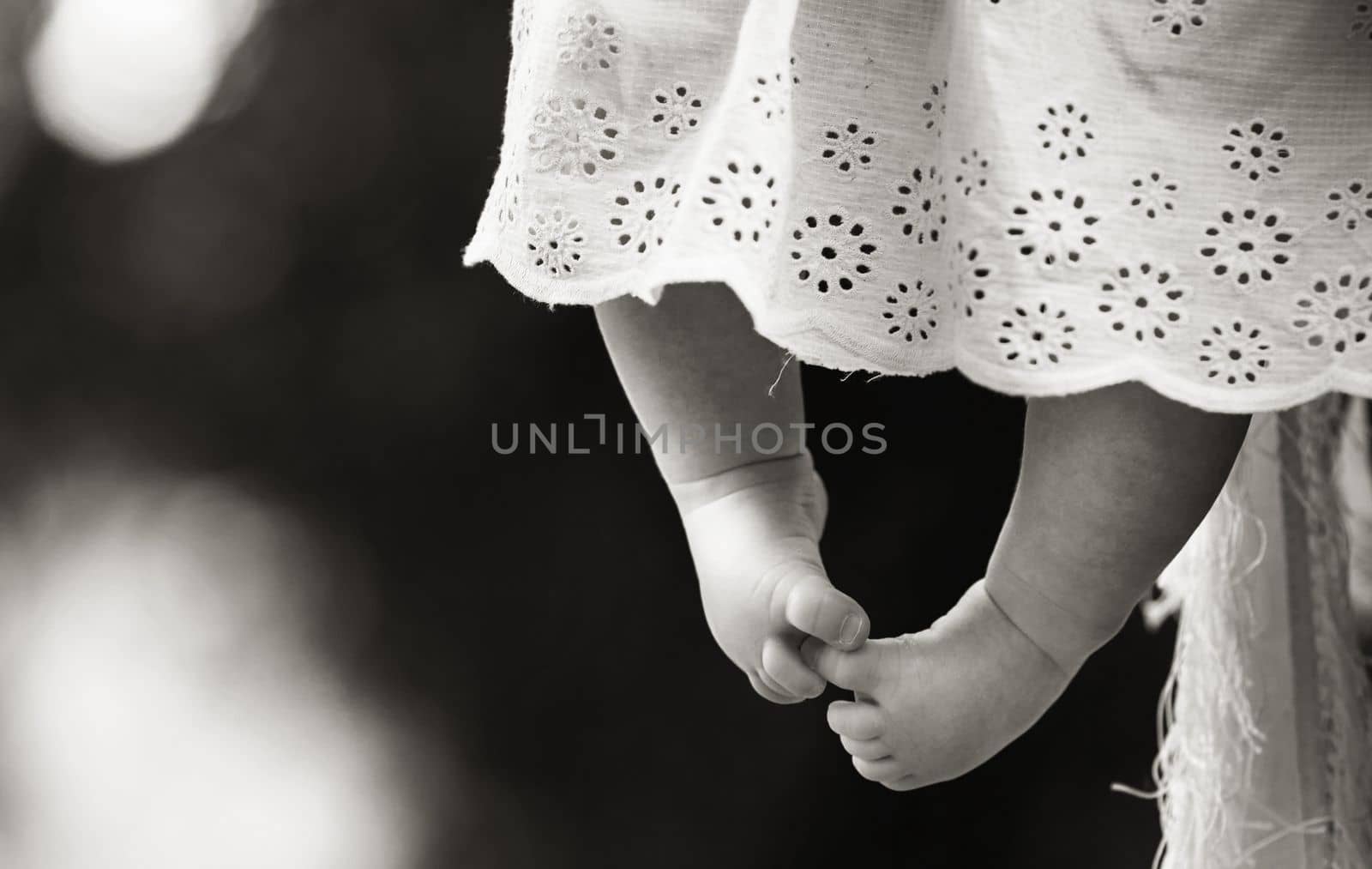 Children's bare feet. Child's healthy bare feet on black and white background. Baby feet. Tiny toddler's feet close up. High quality photo