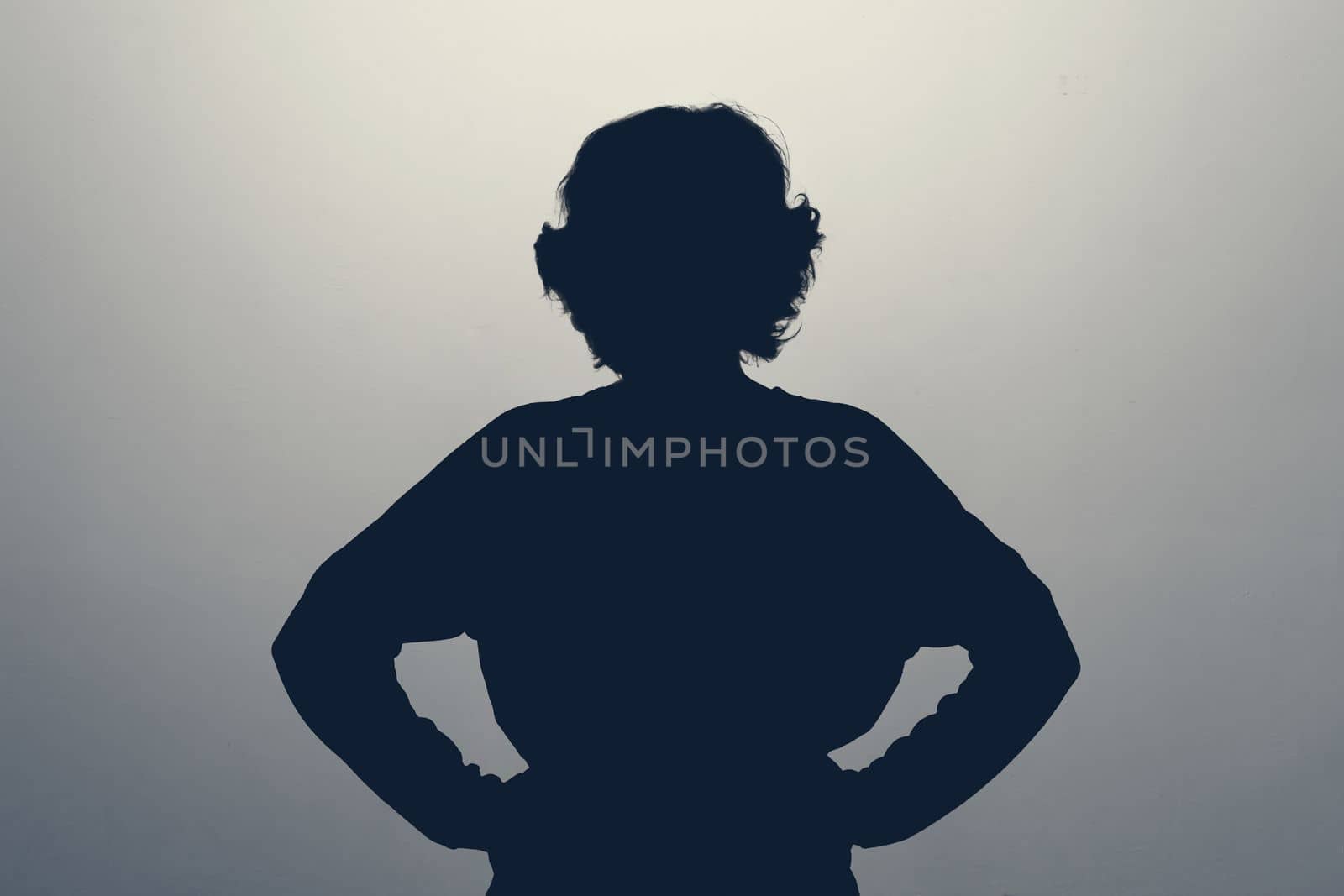 Unknown female person silhouette in studio. Anonym, hide identity.