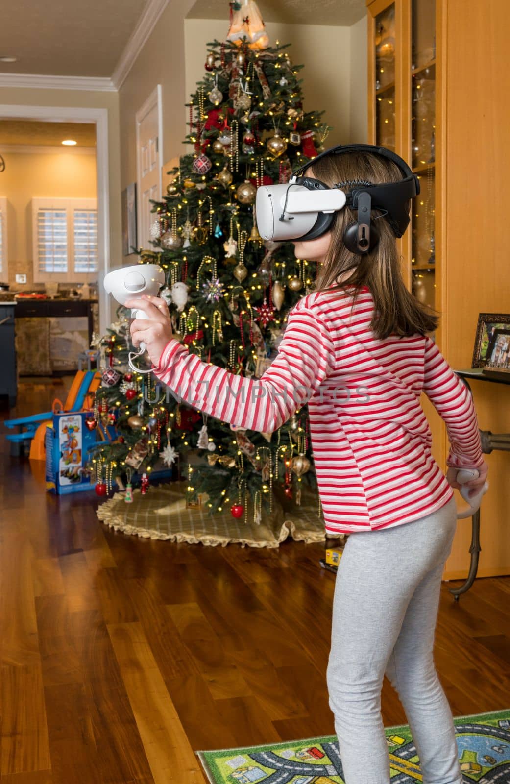 Young girl playing a game on a modern VR headset by steheap