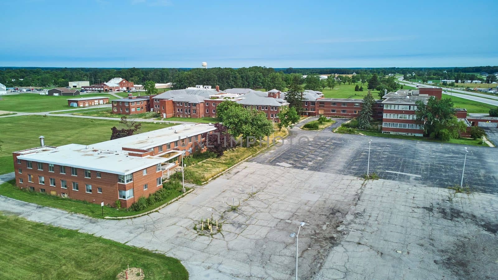 Aerial over huge abandoned brick hospital in Indiana by njproductions
