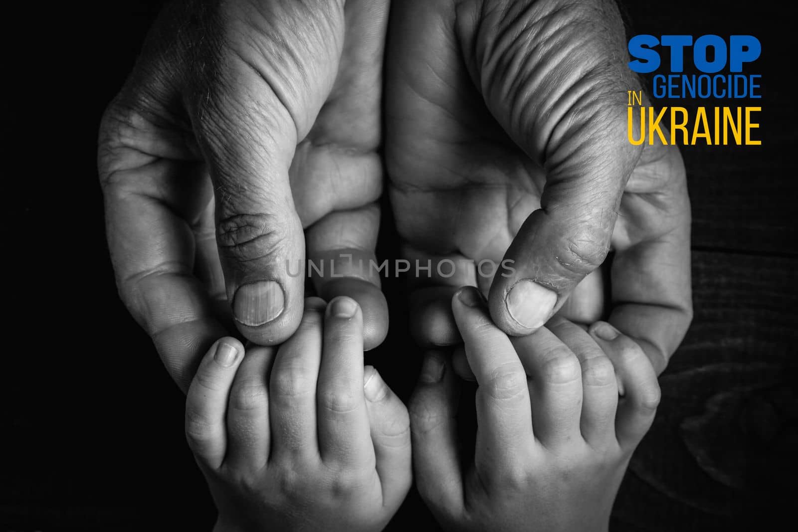 male hands hold childrens on a dark background with words stop genocide in ukraine black and white color and close up. concept needs help and support, truth will win