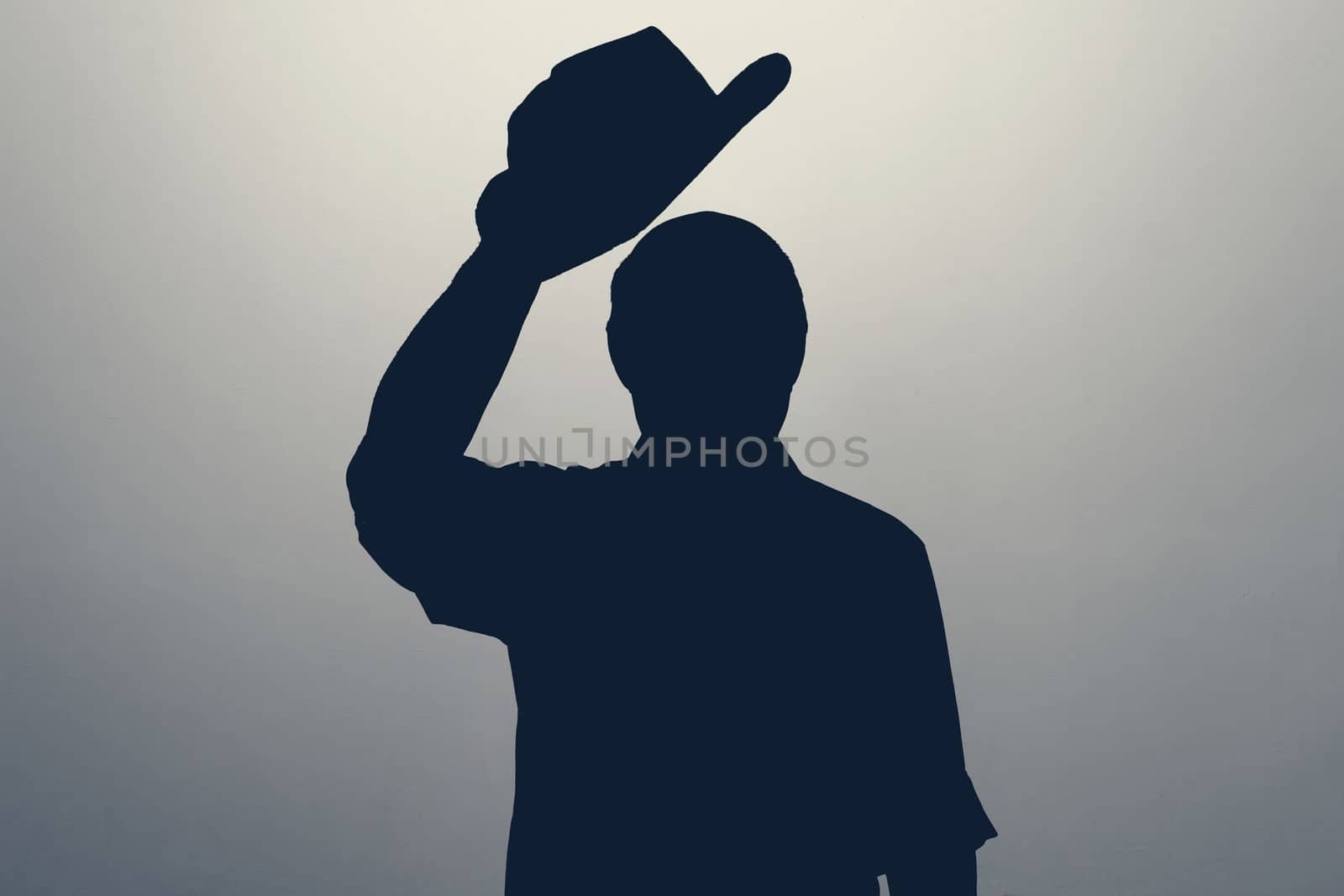 Silhouette of man waving his hat saying hello or welcome. Anonym club concept. You are welcome.