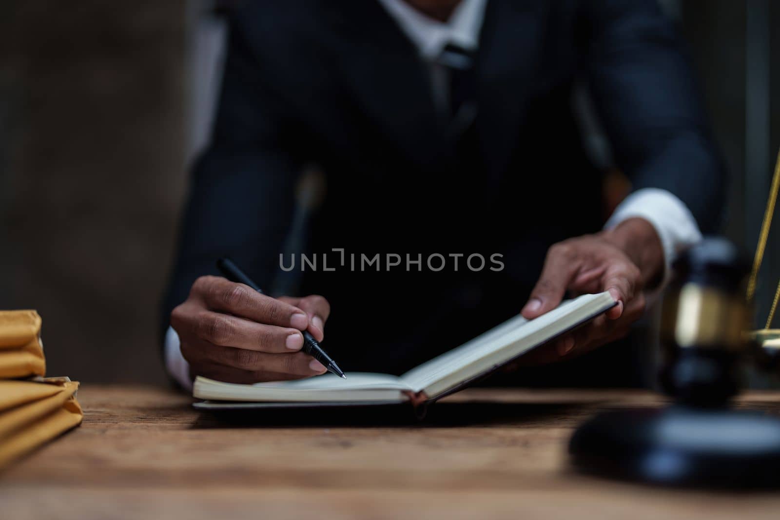 Close up lawyer businessman working or reading lawbook in office workplace for consultant lawyer concept. Law, legal services, advice, Justice concept.