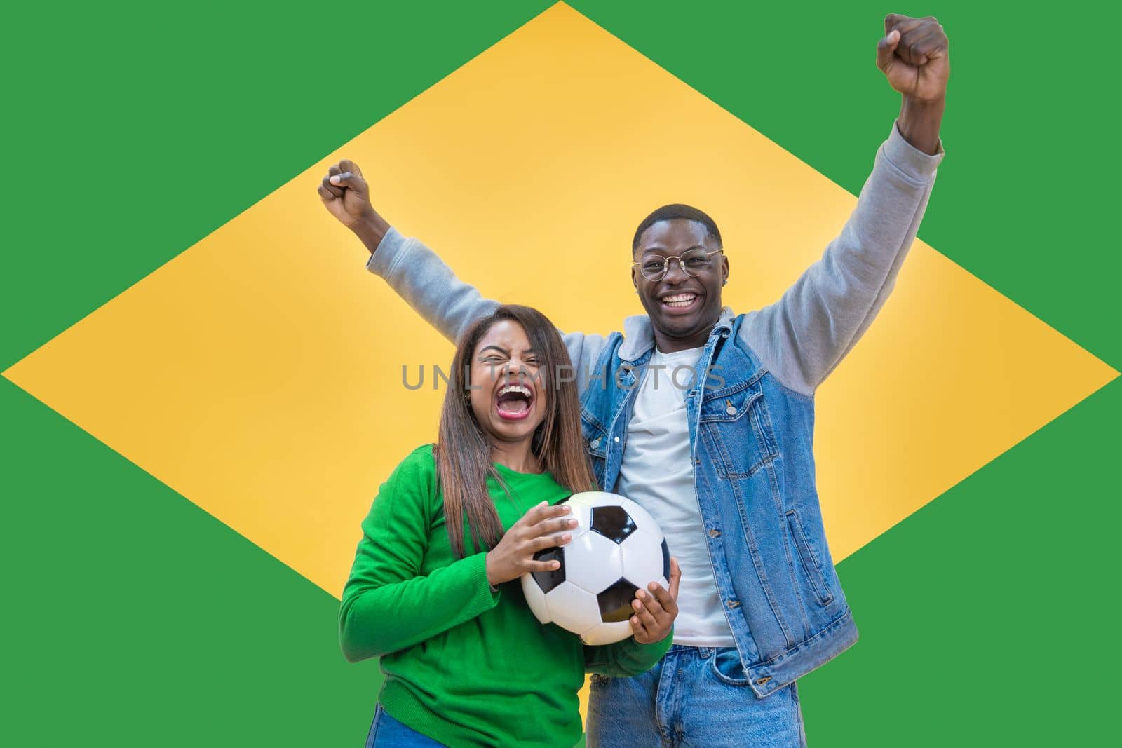 Brazilian fans couple happy celebrating football or soccer game on yellow and green background by PaulCarr
