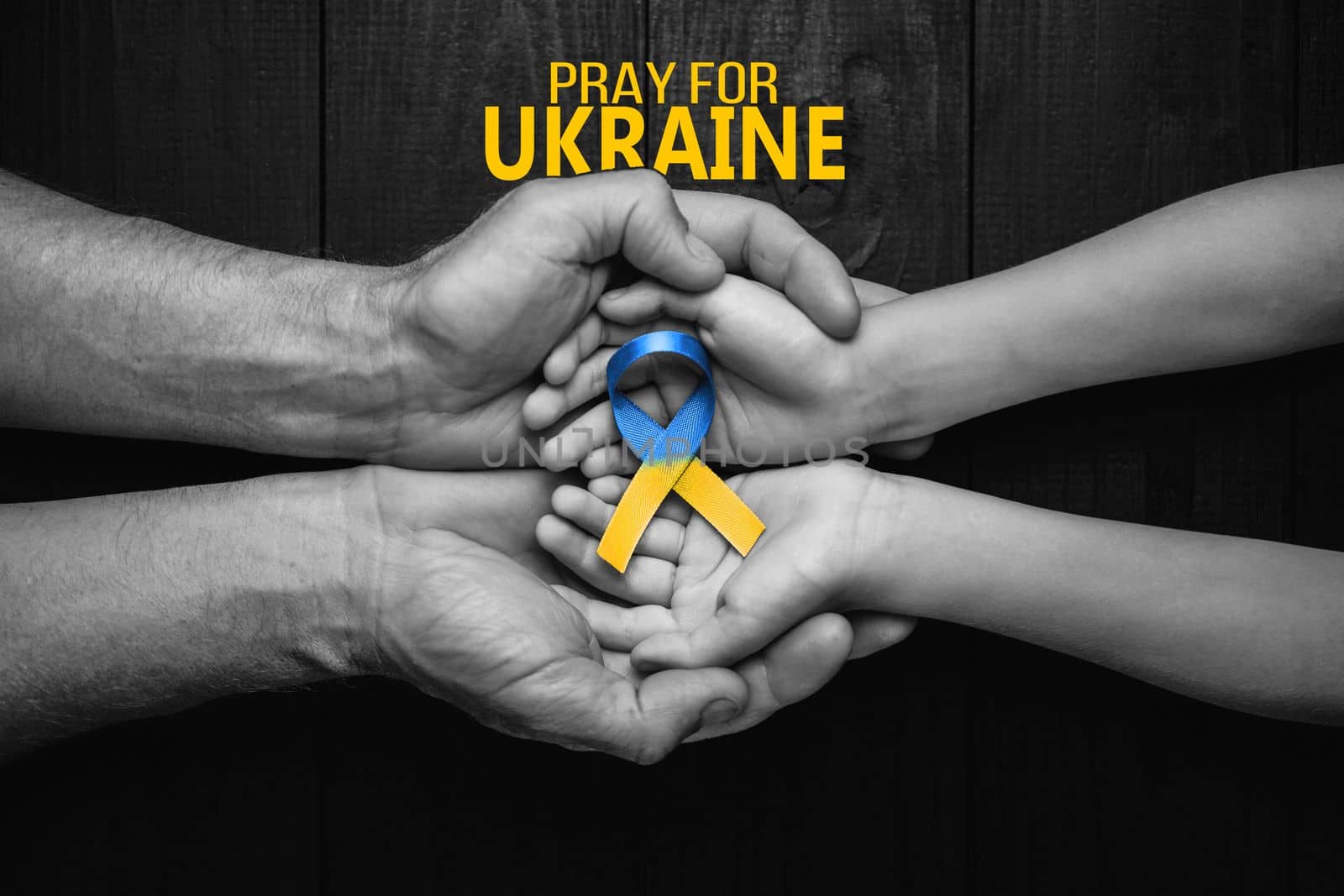 male hands hold childrens on dark background with words pray for Ukraine. concept needs help and support, truth will win