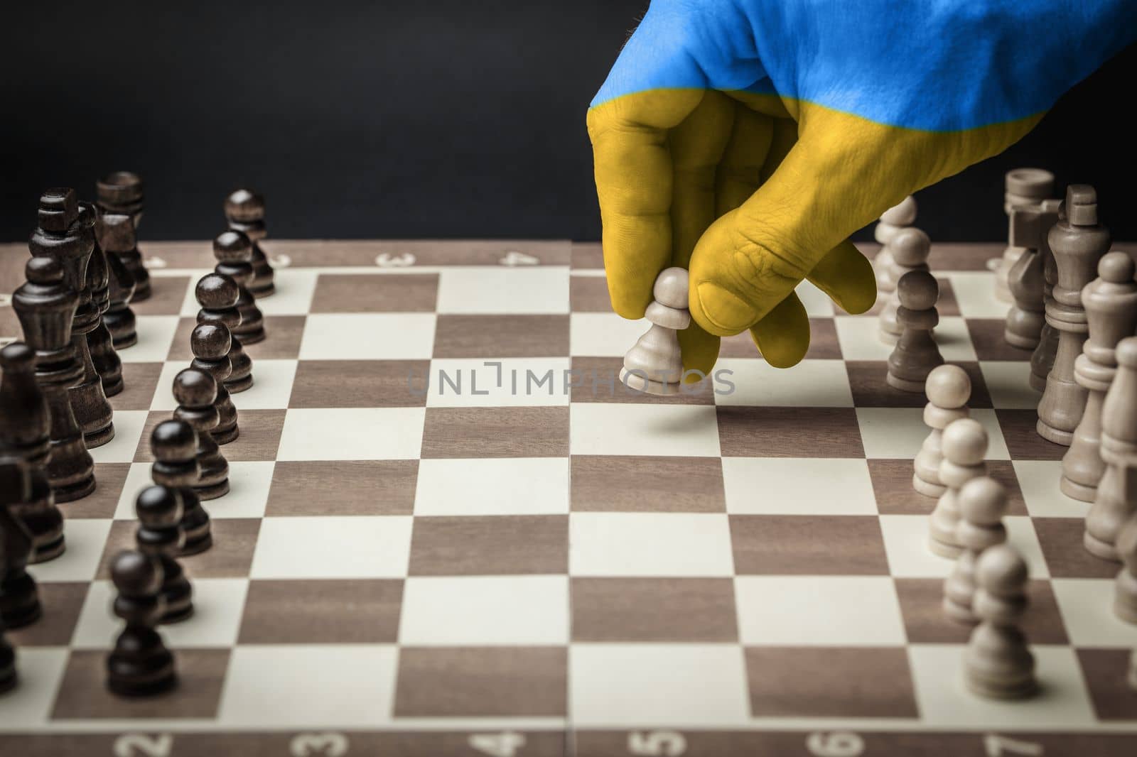 chess board as battlefield in ukraine, with yellow blue hand making decisive step. concept needs help and support, truth will win