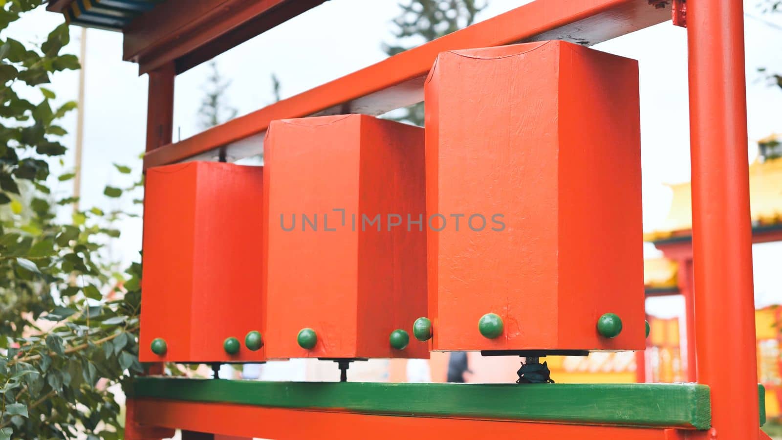 Rotation of the red prayer drums outside the Buddhist temple