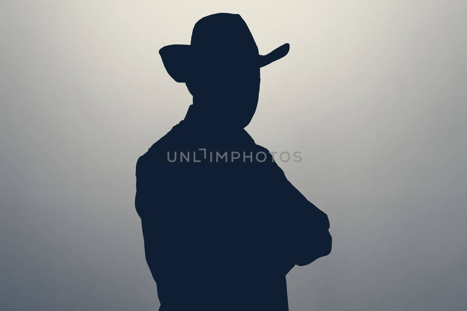 Unknown male person in cowboy hat silhouette in studio. Concept of anonymous or hidden secret.