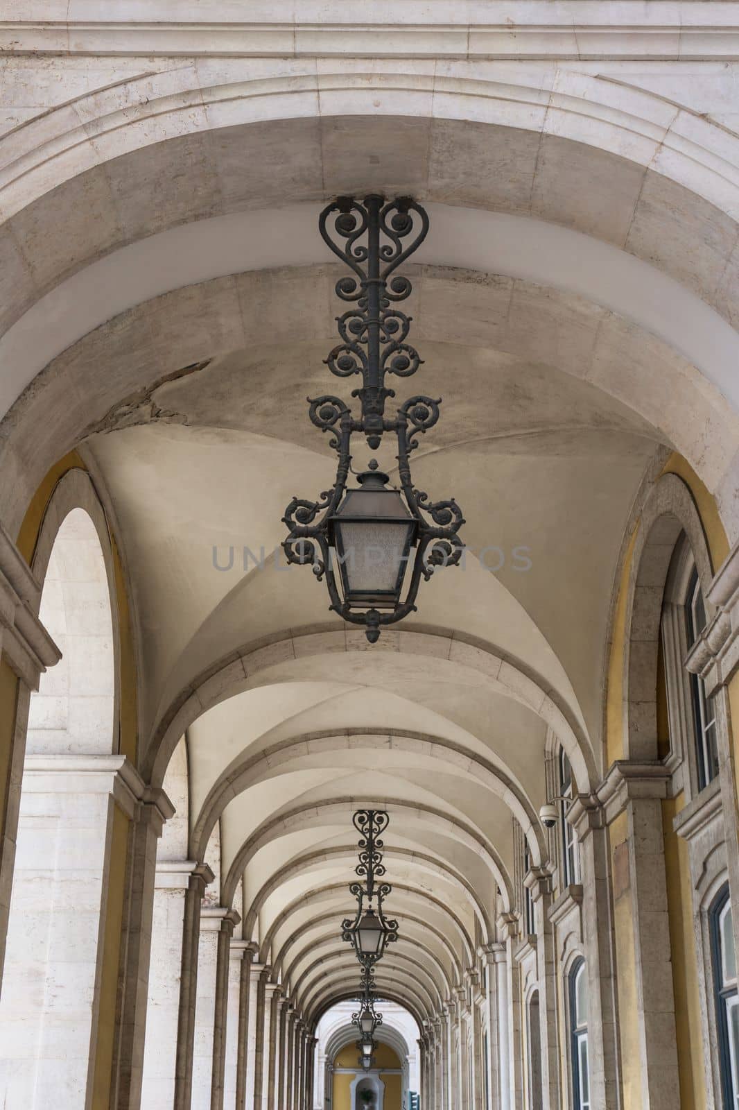 Light vaulted corridor with hanging lamps of Ribeira Palace in Lisboa, Portugal