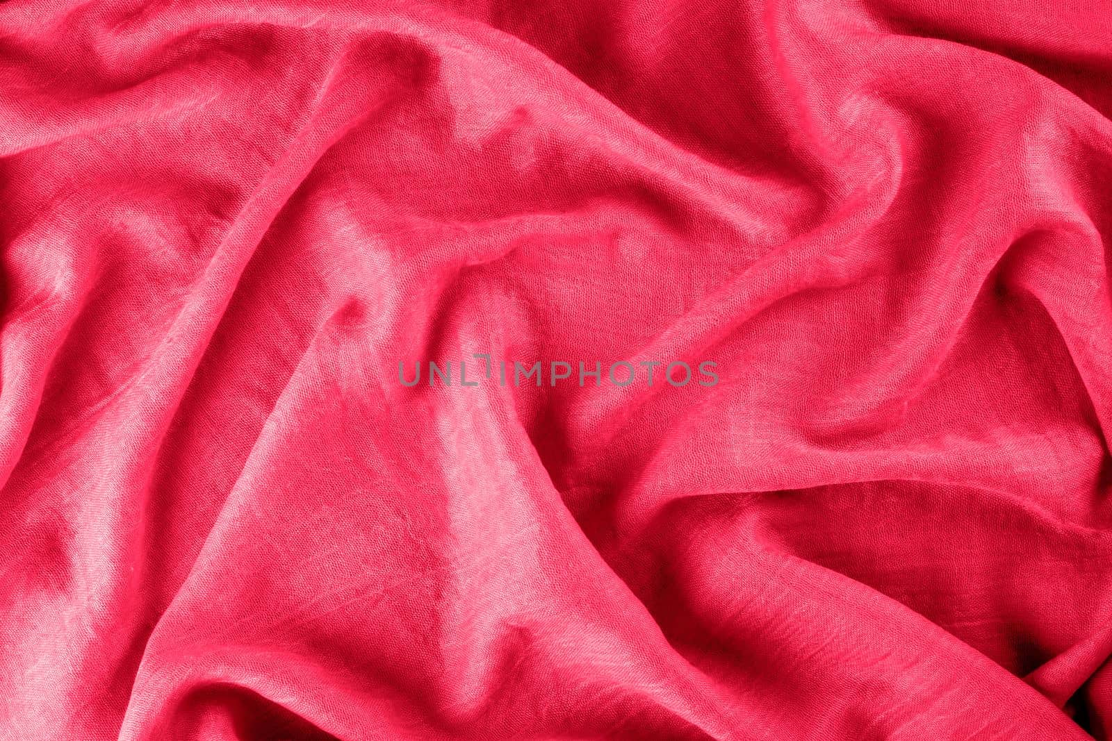 Close-up of draped fabric as background. Viva magenta, color of year 2022 Selective focus.