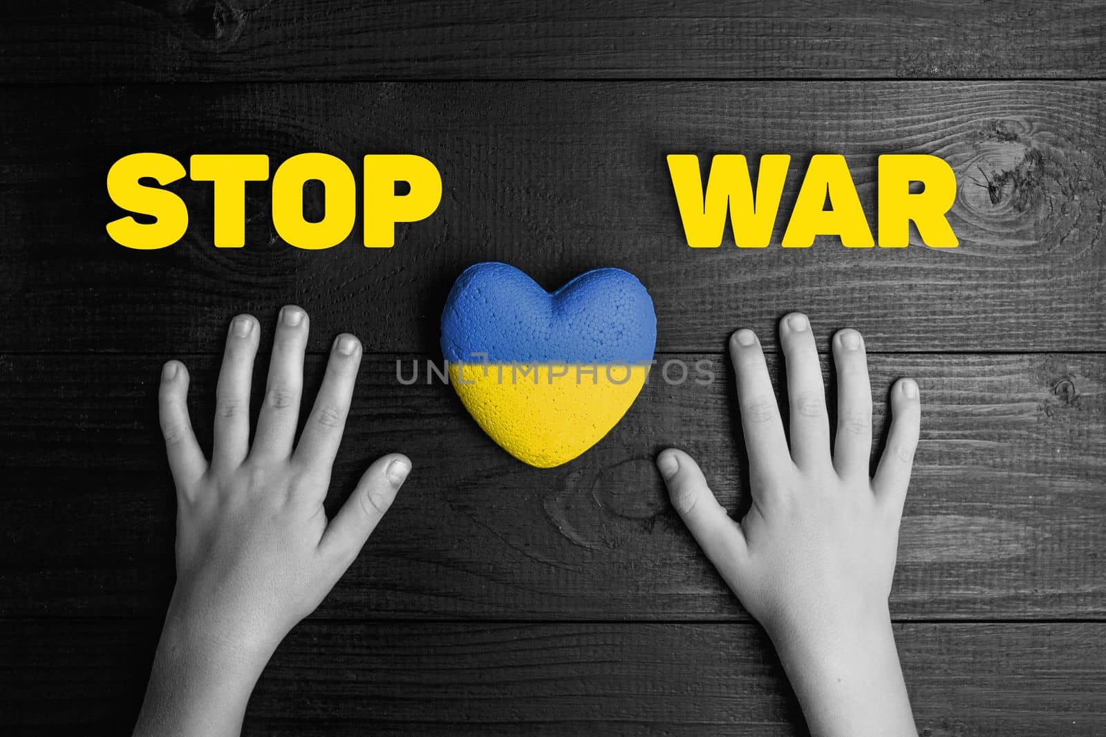hands with painted yellow and blue heart, with words stop war in ukraine. black and white color. concept needs help and support, truth will win