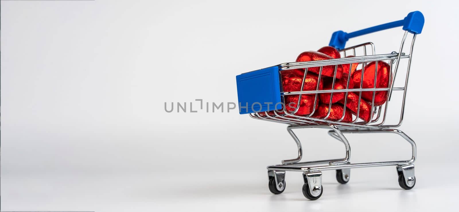 Supermarket trolley loaded with heart-shaped candies by audiznam2609