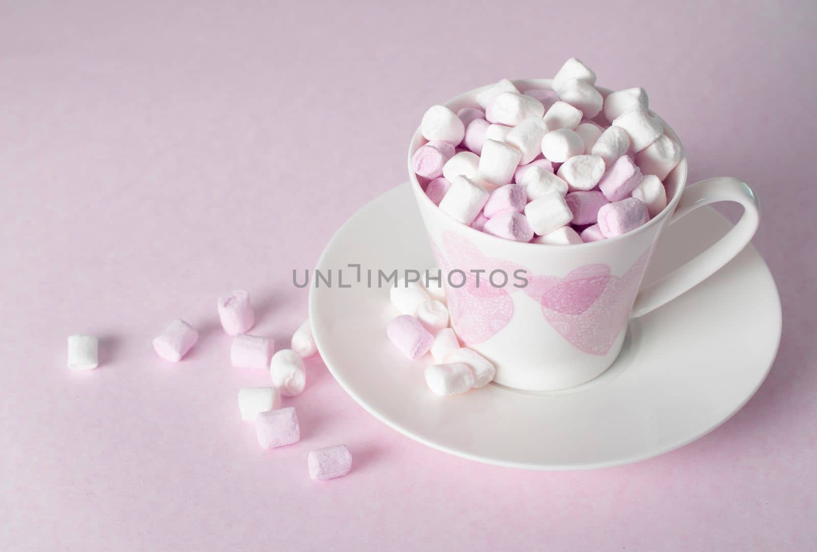 light pink and white marshmallows in a beautiful ceramic cups with pink hearts, Concept Mother's Day gift, Valentine's Day. High quality photo