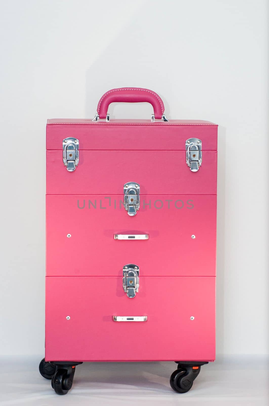 professional makeup artist's cosmetic bag, pink suitcase close-up, by KaterinaDalemans