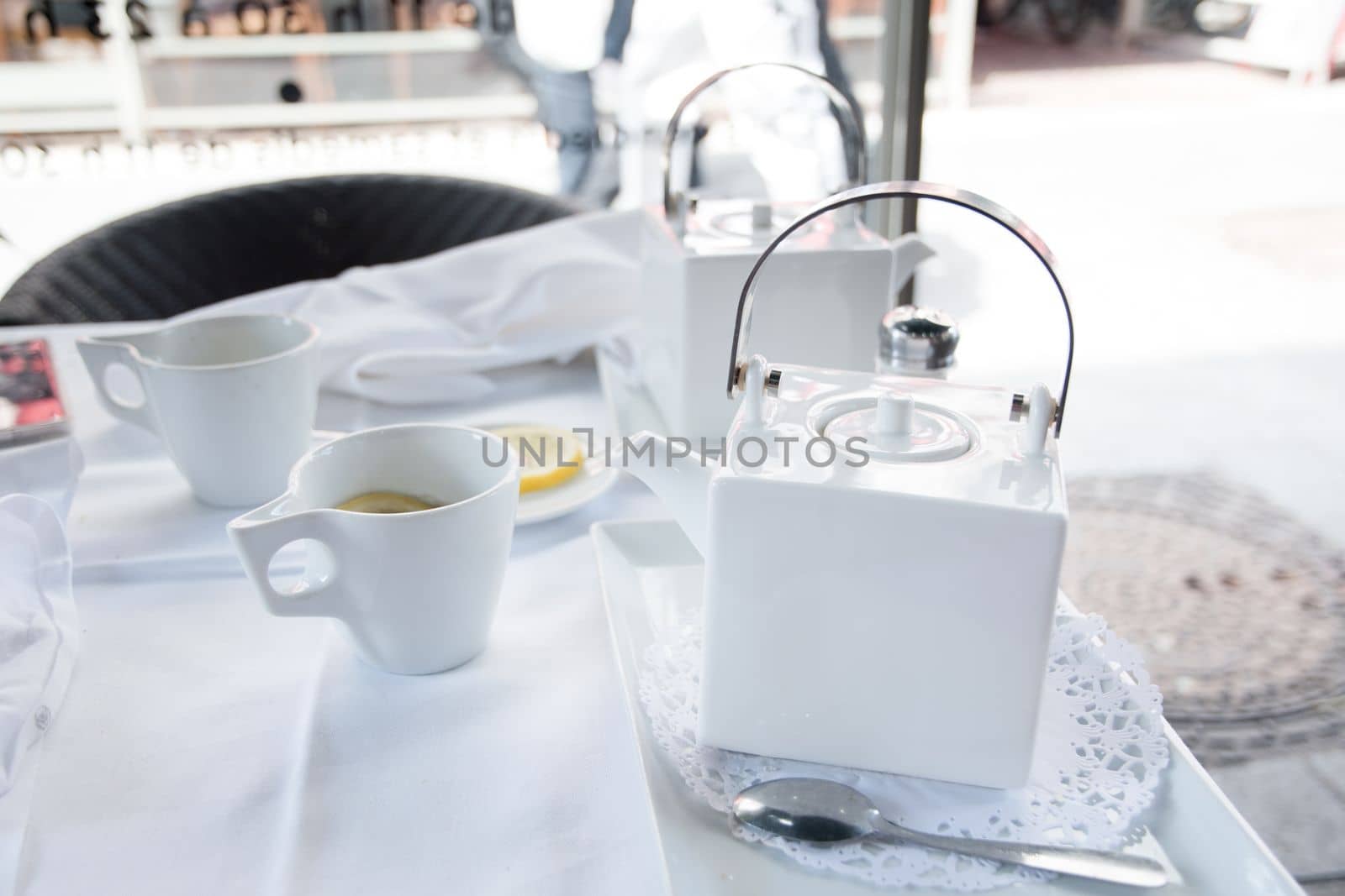 tea break with a white tea set at a table in a cafe in the city, High quality photo