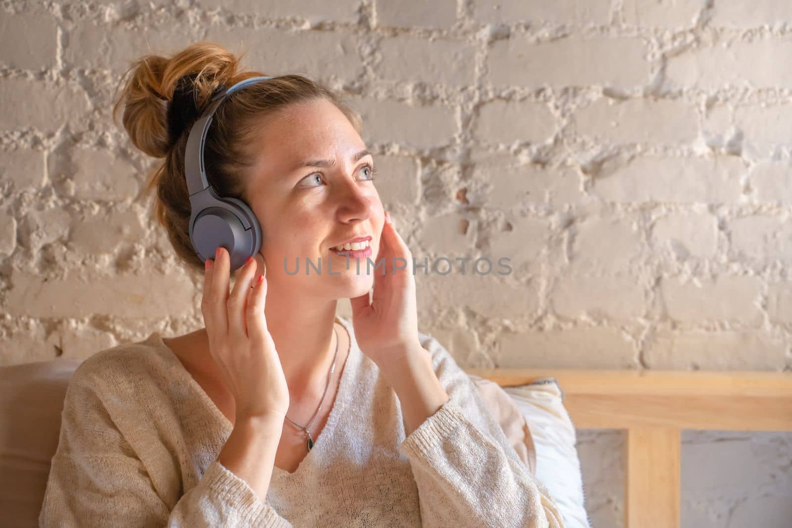 Portrait of a pretty young female with headphone listening music by PaulCarr