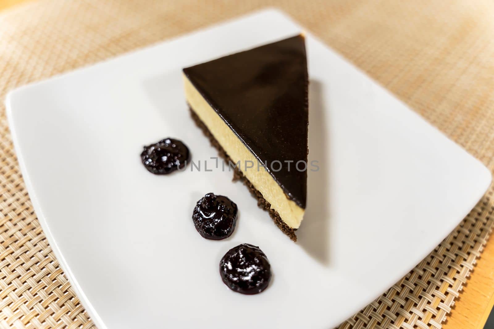a delicious beautifully decorated piece of cake on a plate on the table. Slice of cheesecake. High quality photo
