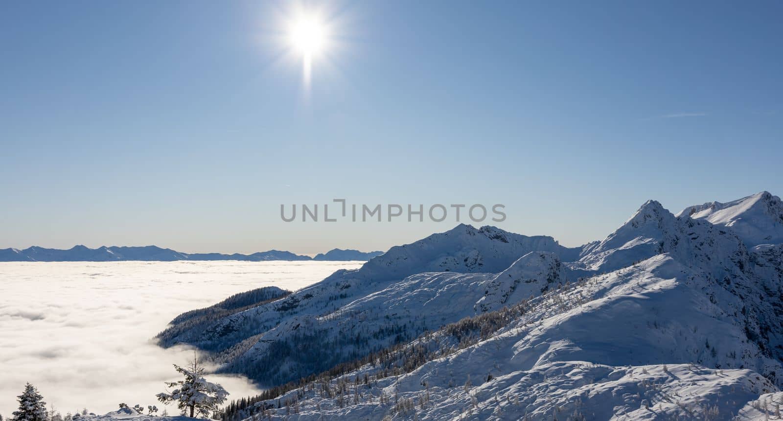 Winter mountains covered with snow landscape over clouds. High quality photo