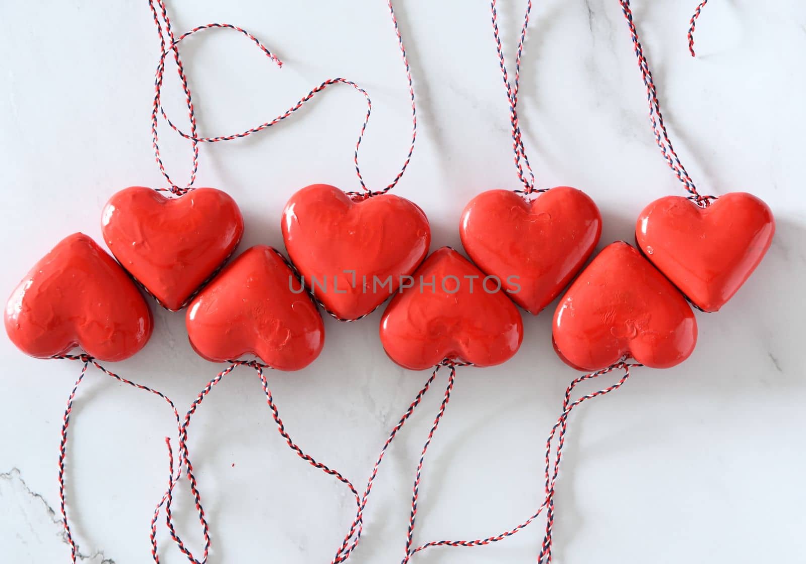 red toy hearts on the white wooden table, gift valentine's day concept, by KaterinaDalemans