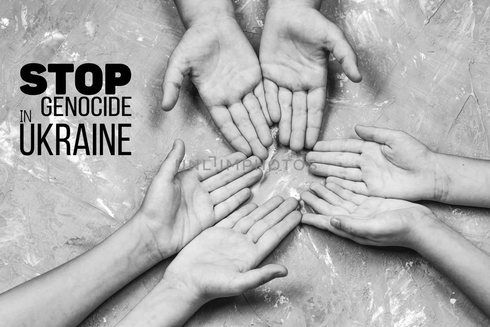 childrens hands with palms up on gray background, with words stop genocide in ukraine. black and white color. concept needs help and support, truth will win