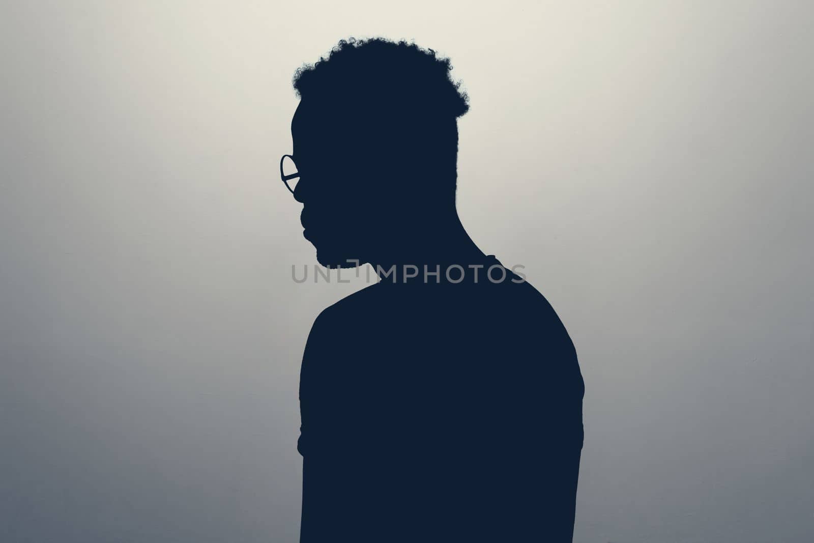 Unknown male person looking aside silhouette in studio. Concept of anonymous or hidden secret.