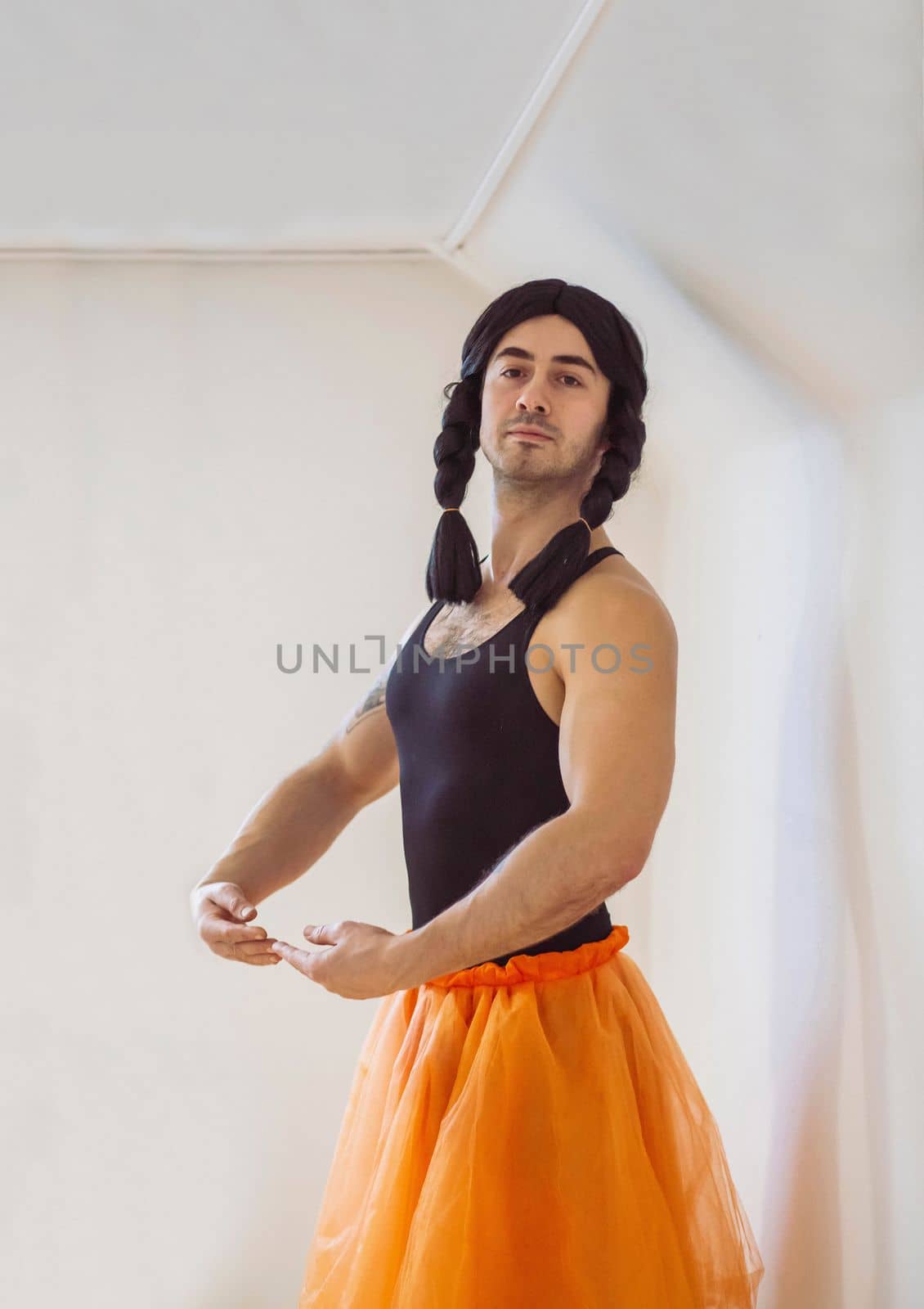Young muscular man pretending to be a ballerina.