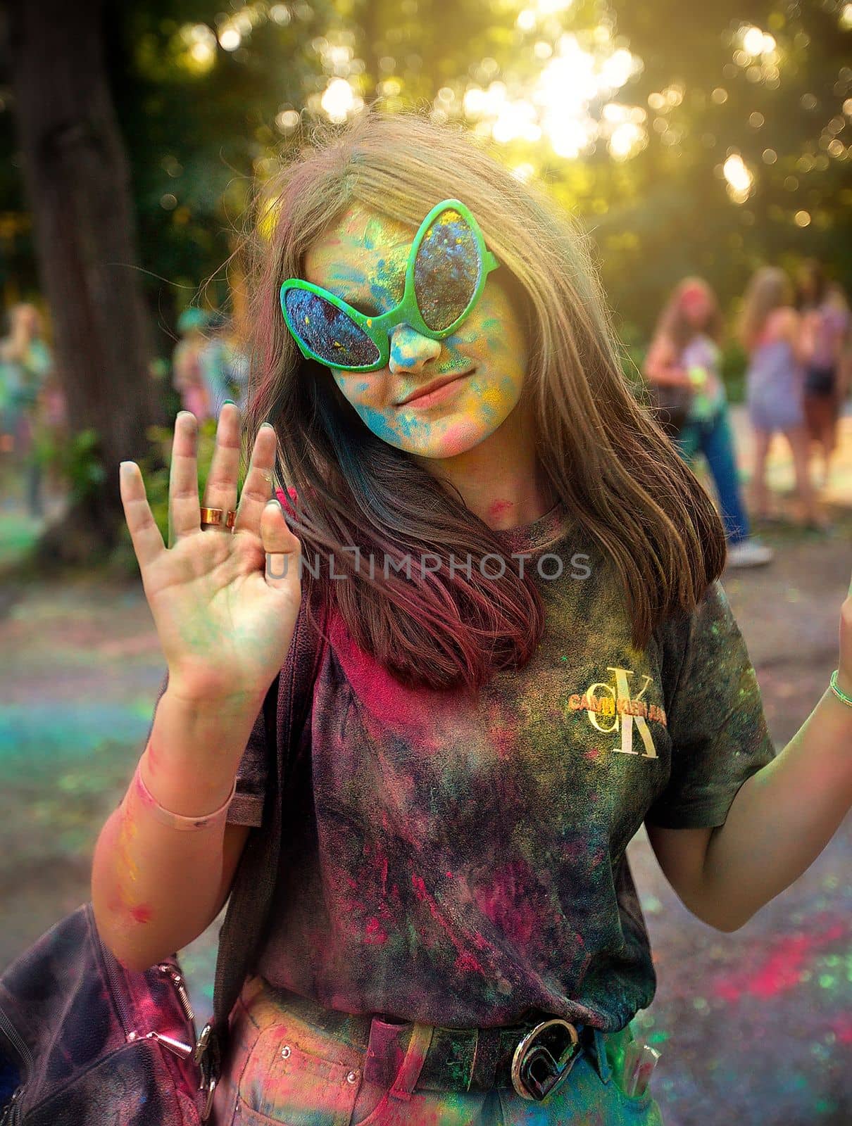 Young people, teenagers and adults celebrate the Holi event in Ukraine in Chernivtsi on March 8 in 2022. They have fun and throw paint at each other. High quality photo