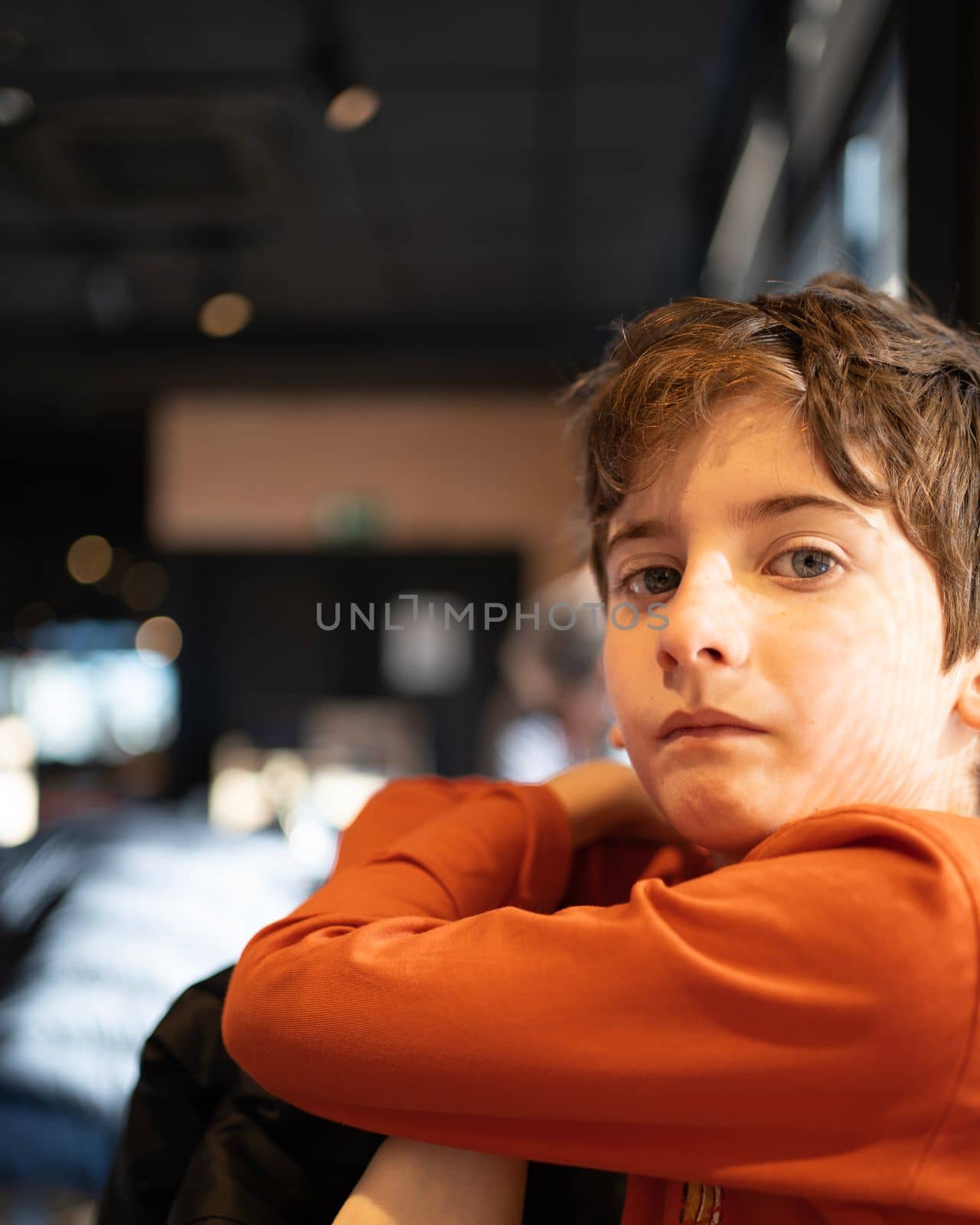 Portrait of caucasian kid with serious face expression.