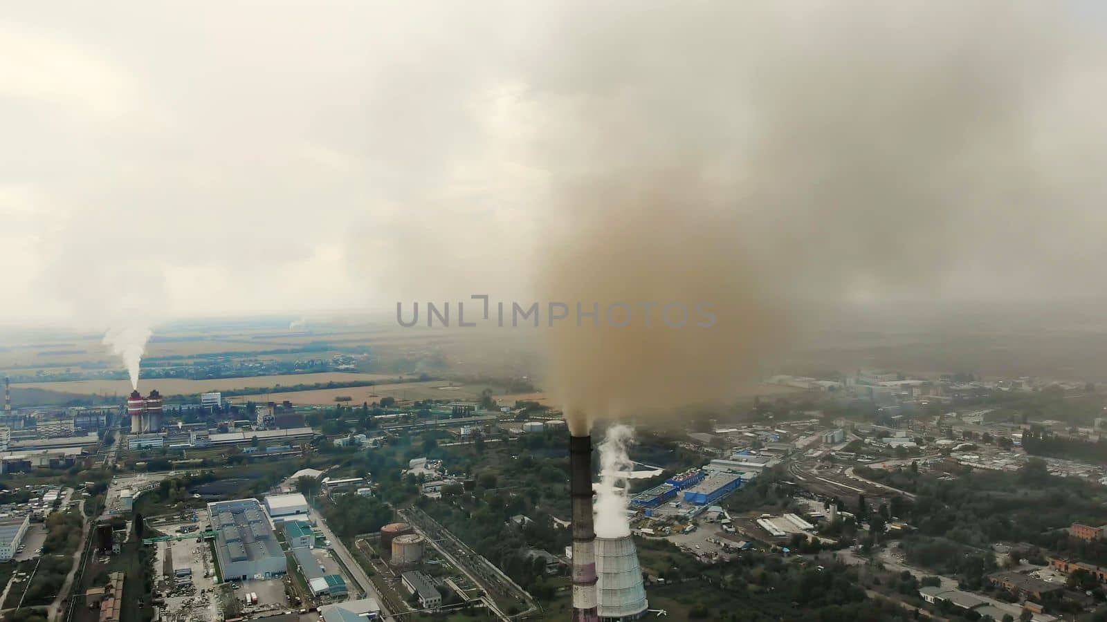 CHERKASY, UKRAINE, SEPTEMBER 12, 2018: Big Power plant , factory with pipes, expelling smoke into sky. Smoke from industrial chimney. ecology, pollution of the environment. High quality photo