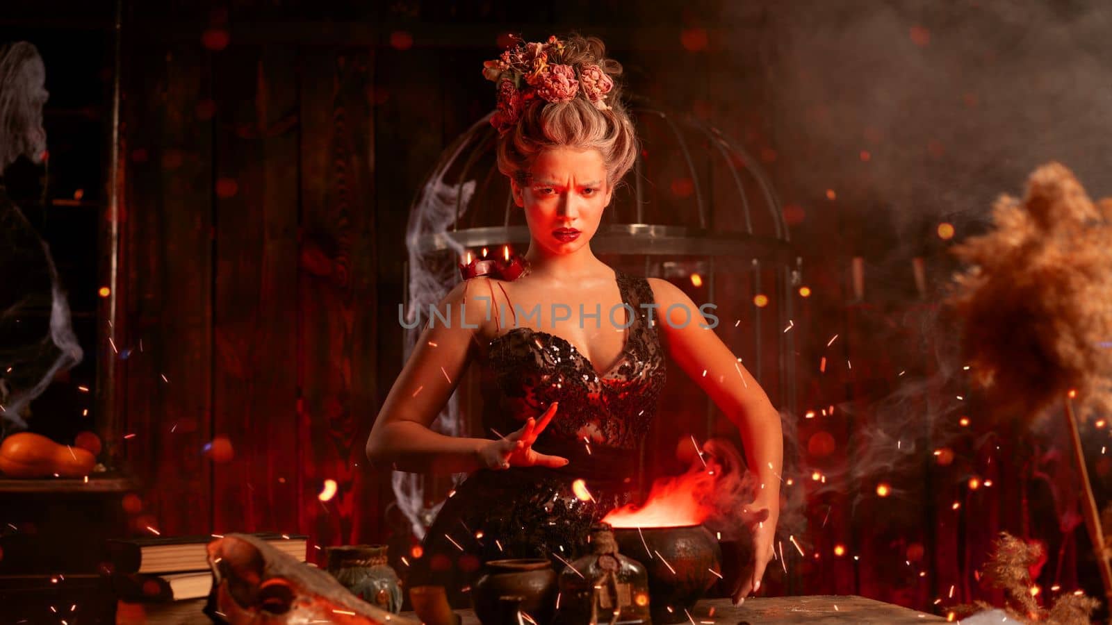 Witch with cauldron. Beautiful young woman conjuring, making witchcraft. Standing spooky dungeon dark room. Enchantress prepare love potion use magic spell