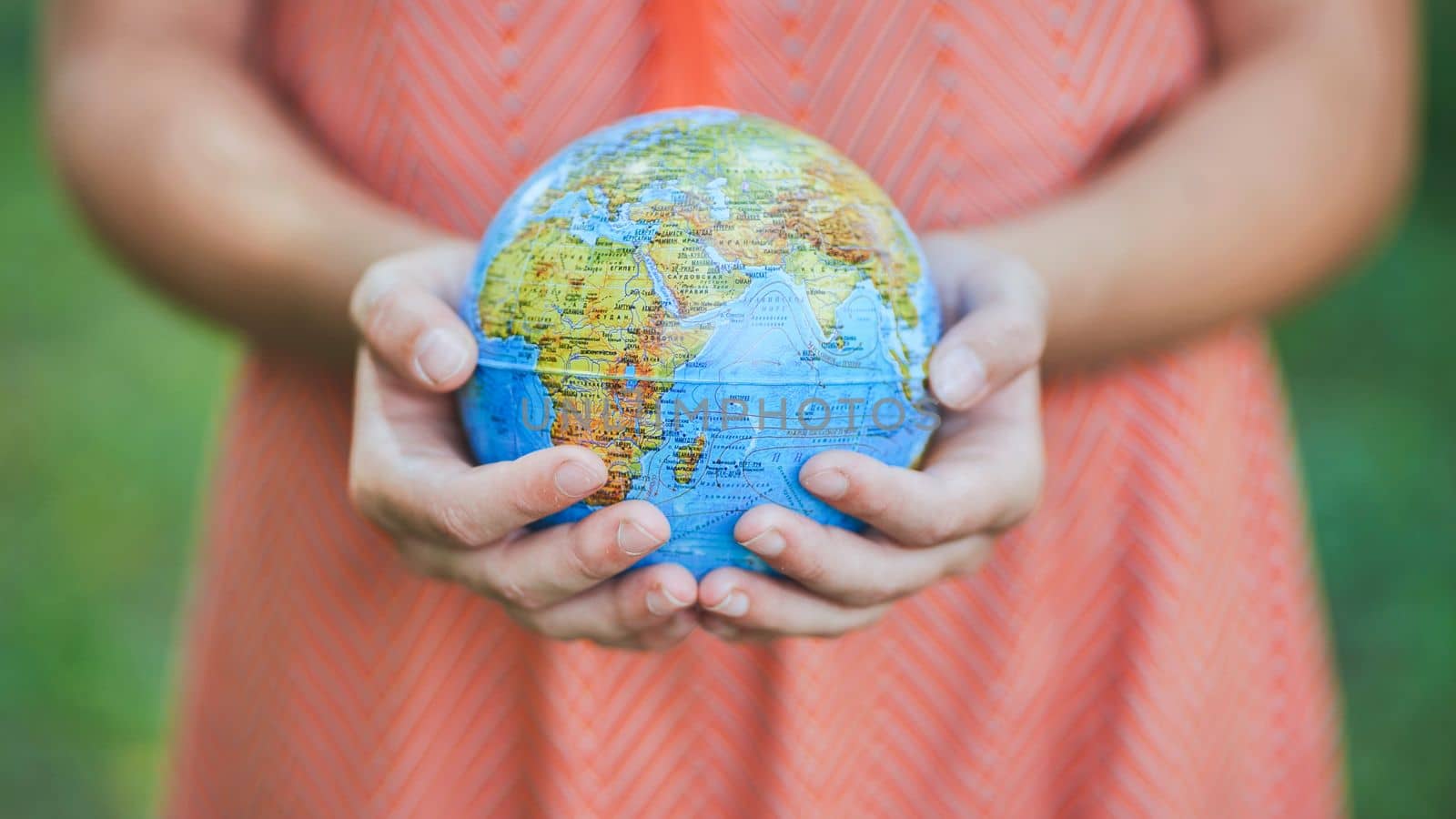 The little one is holding a geographic globe