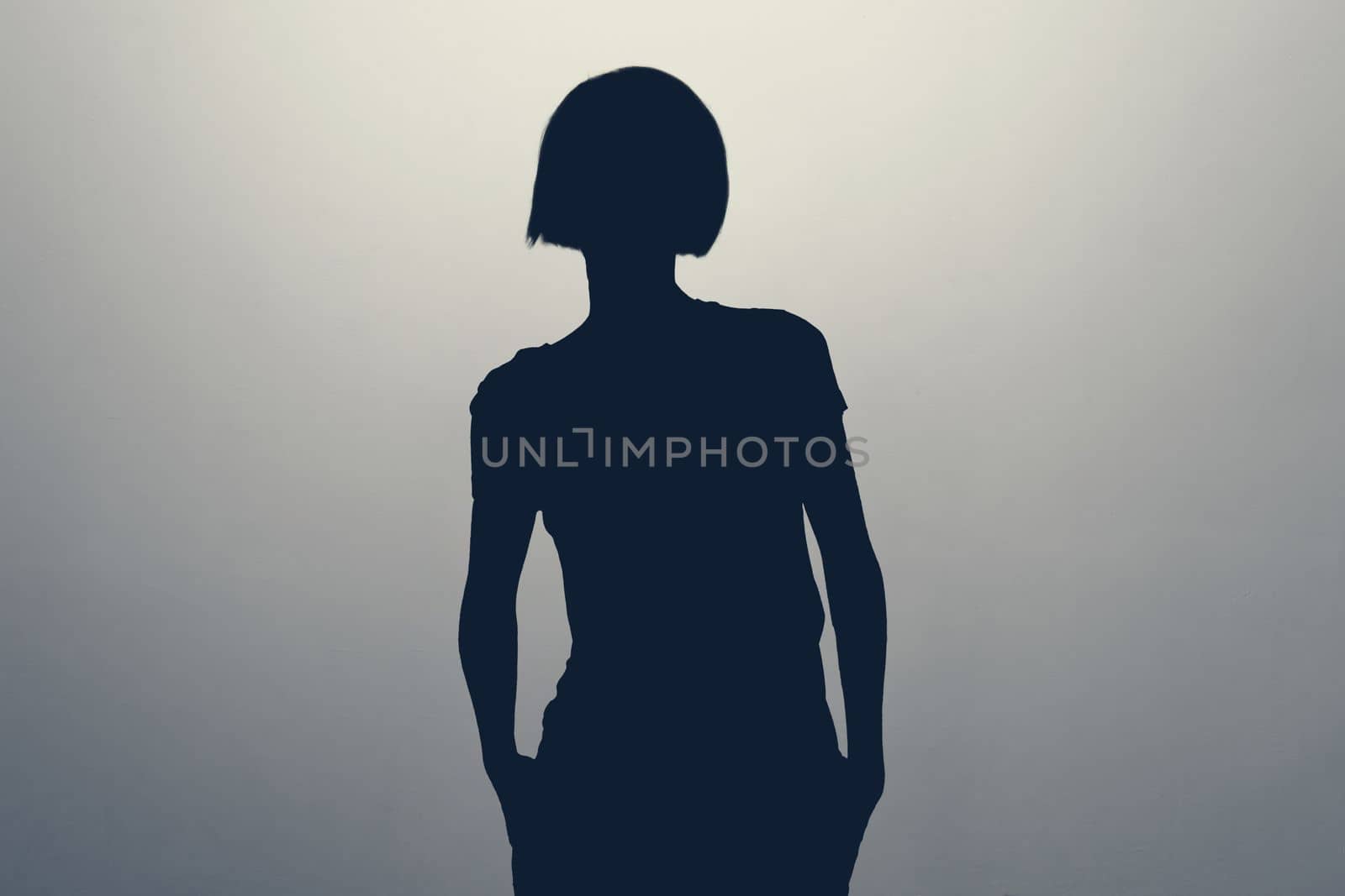 Unknown female person silhouette in studio. Anonym unrecognizable woman. Hiding identity