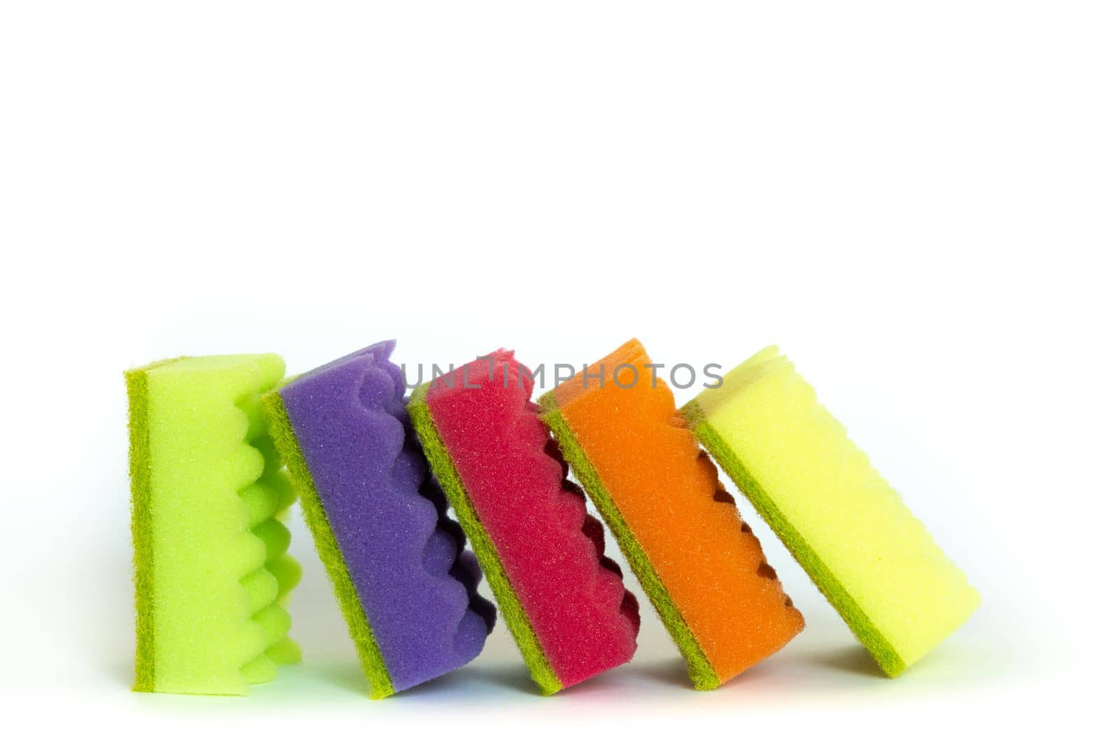 Stack of many multi-colored dish wash sponges isolated on white background. Household cleaning scrub pad. Home cleaning concept. Space for text by Ri6ka