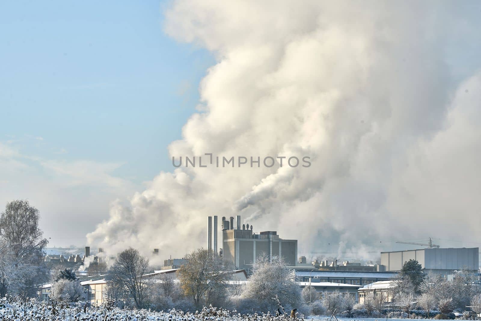 Environmental problem of pollution of environment and air in cities. Smoking industrial zone factory chimneys. View of large plant with Smoking pipes Smoke from the paper industry, which is running every day of the year. Photo taken December 2022 Air pollution in the city. Smoke from the chimney on blue sky background. High quality photo