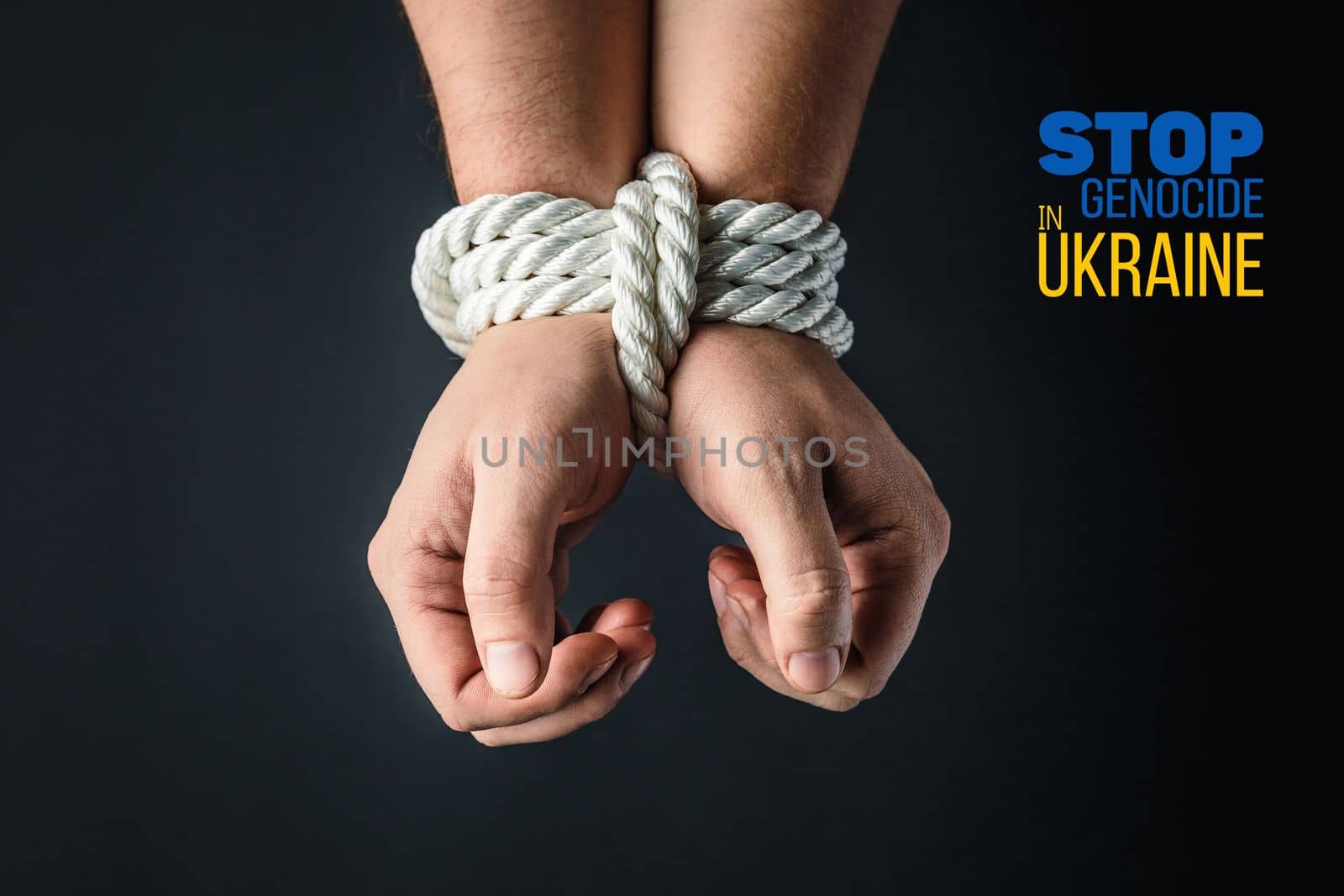 tightly tied hands with a white rope on dark background, violence and kidnapping. with words stop genocide in ukraine. concept needs help and support, truth will win