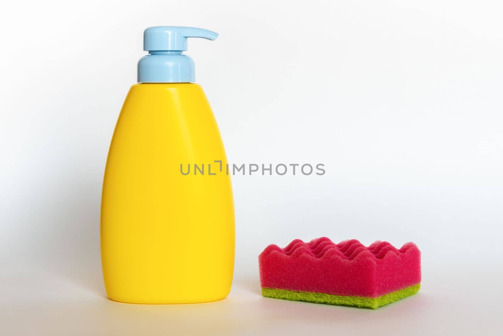 Pink dish wash sponges with bottle of soap. Household cleaning scrub pad. Home cleaning concept. by Ri6ka