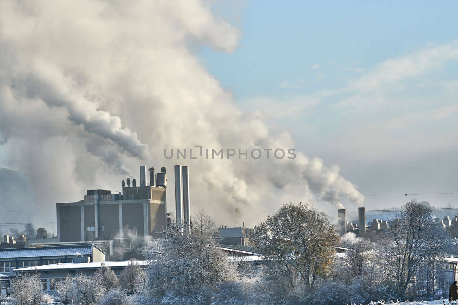 Environmental problem of pollution of environment and air in cities. Smoking industrial zone factory chimneys. View of large plant with Smoking pipes Smoke from the paper industry, which is running every day of the year. Photo taken December 2022 Air pollution in the city. Smoke from the chimney on blue sky background. by Costin