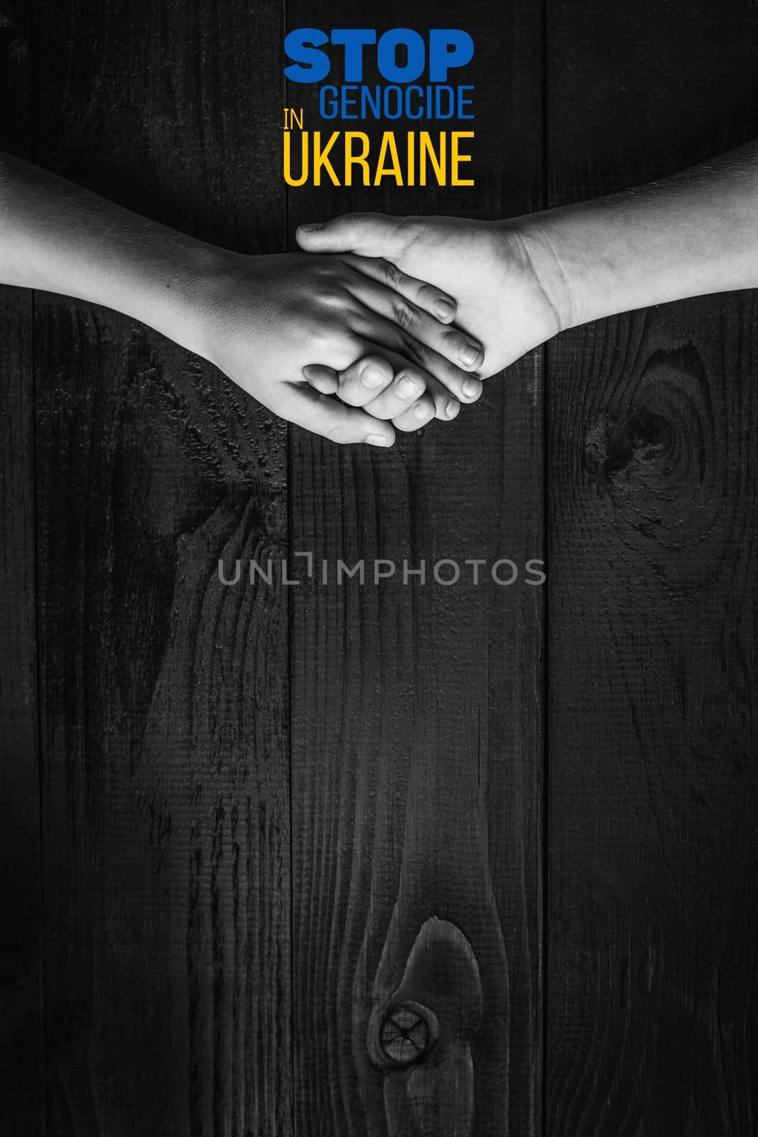 childrens hands holding each other with words stop genocide in ukraine black and white color. concept needs help and support, truth will win