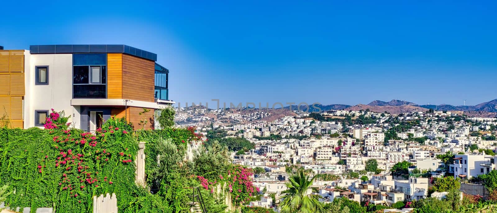 Beautiful modern log house in the mountains in Turkey with city view. download image by igor010