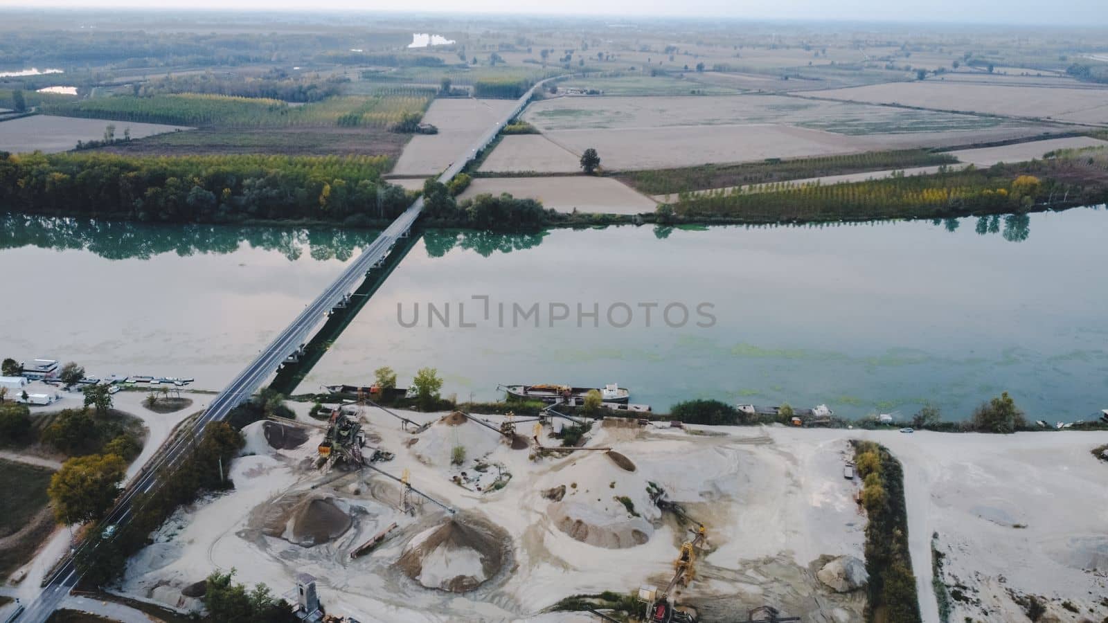Top view of large manufacturing plant in landscape by the river Po, Piacenza Italy