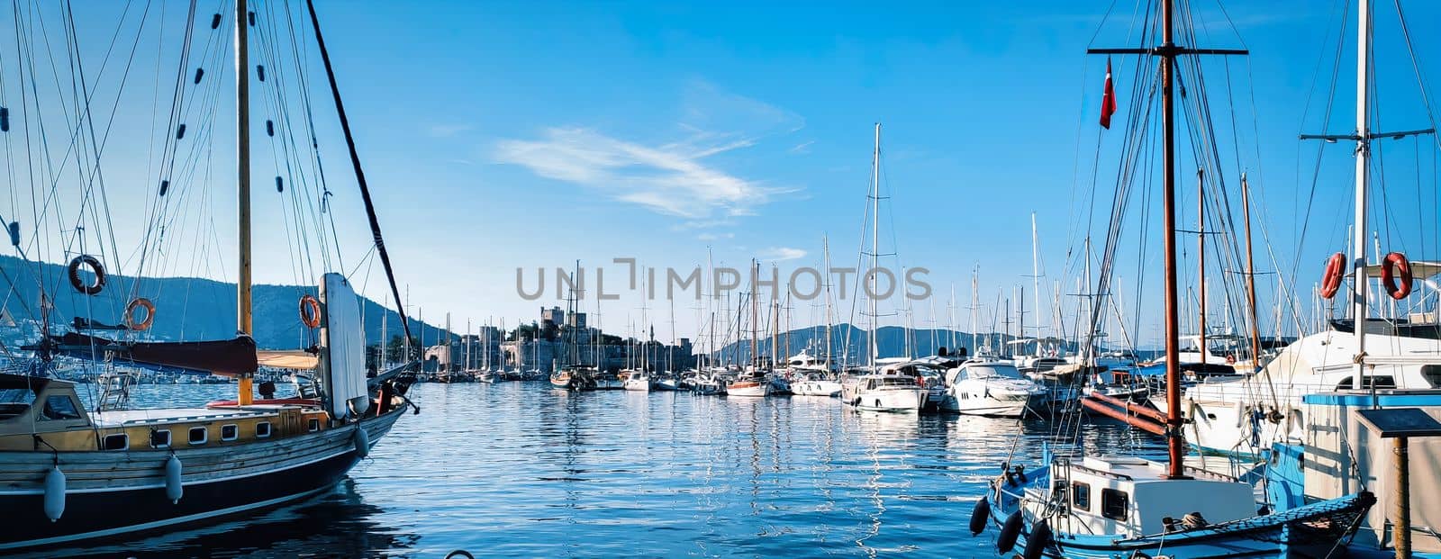 Picture of row of sailboats reflected in water, yacht port on the bay, water transport, ocean transportation, beautiful vessel in the harbor, summer vacation, active lifestyle, holiday concept. download image