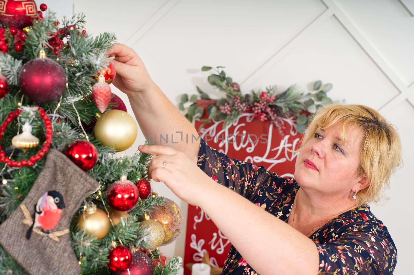 Woman decorating beautiful Christmas tree at home, closeup. christmas holidays and people concept. by PhotoTime