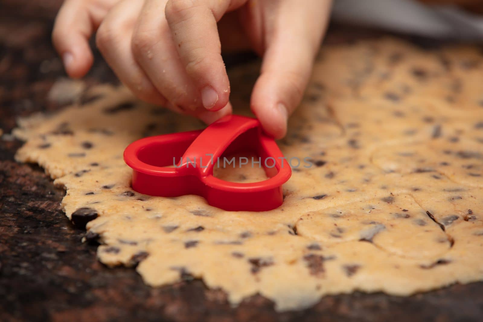 Close-up child`s hands preparing cookies by senkaya