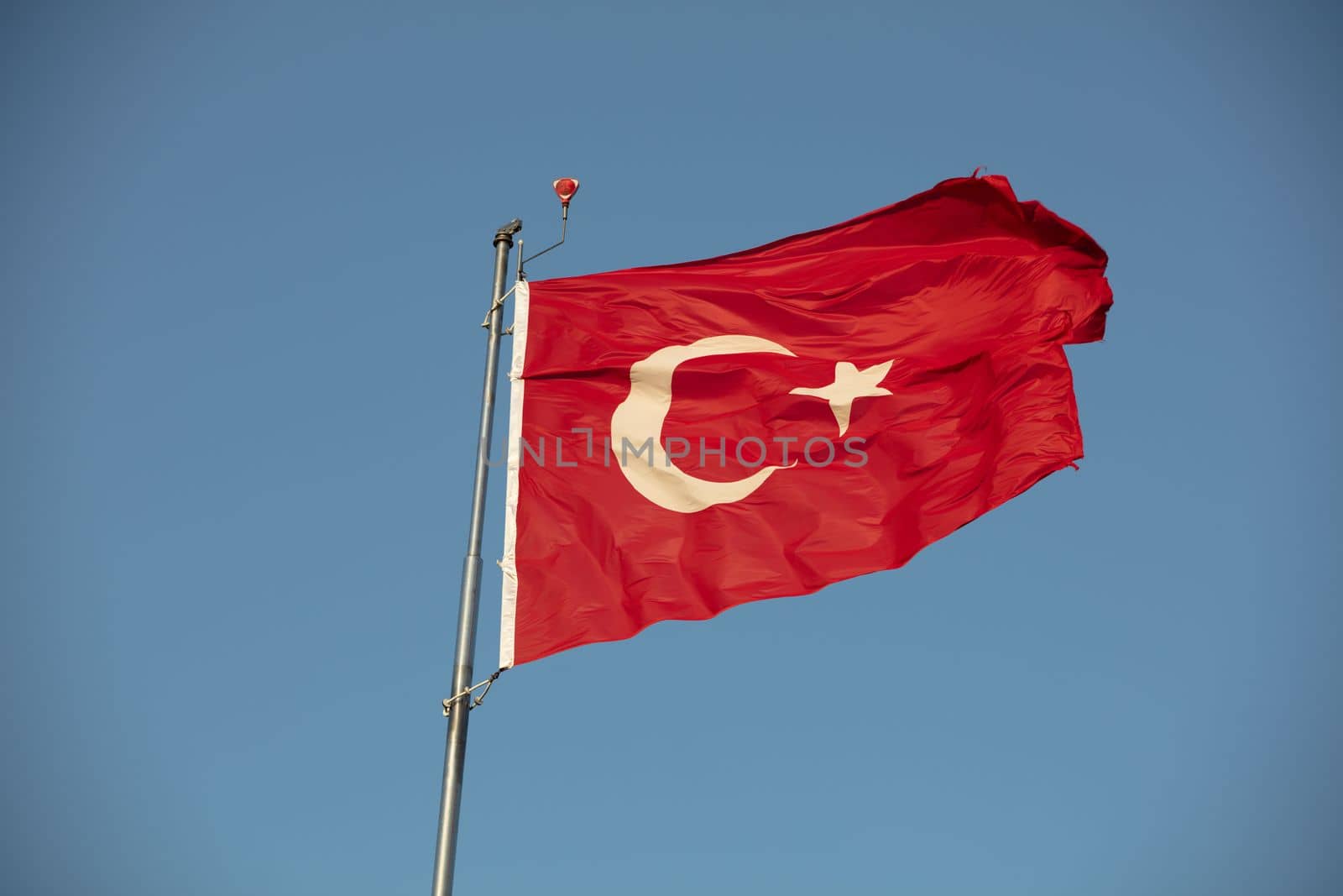 Turkish flag with red and white moon in blue sky