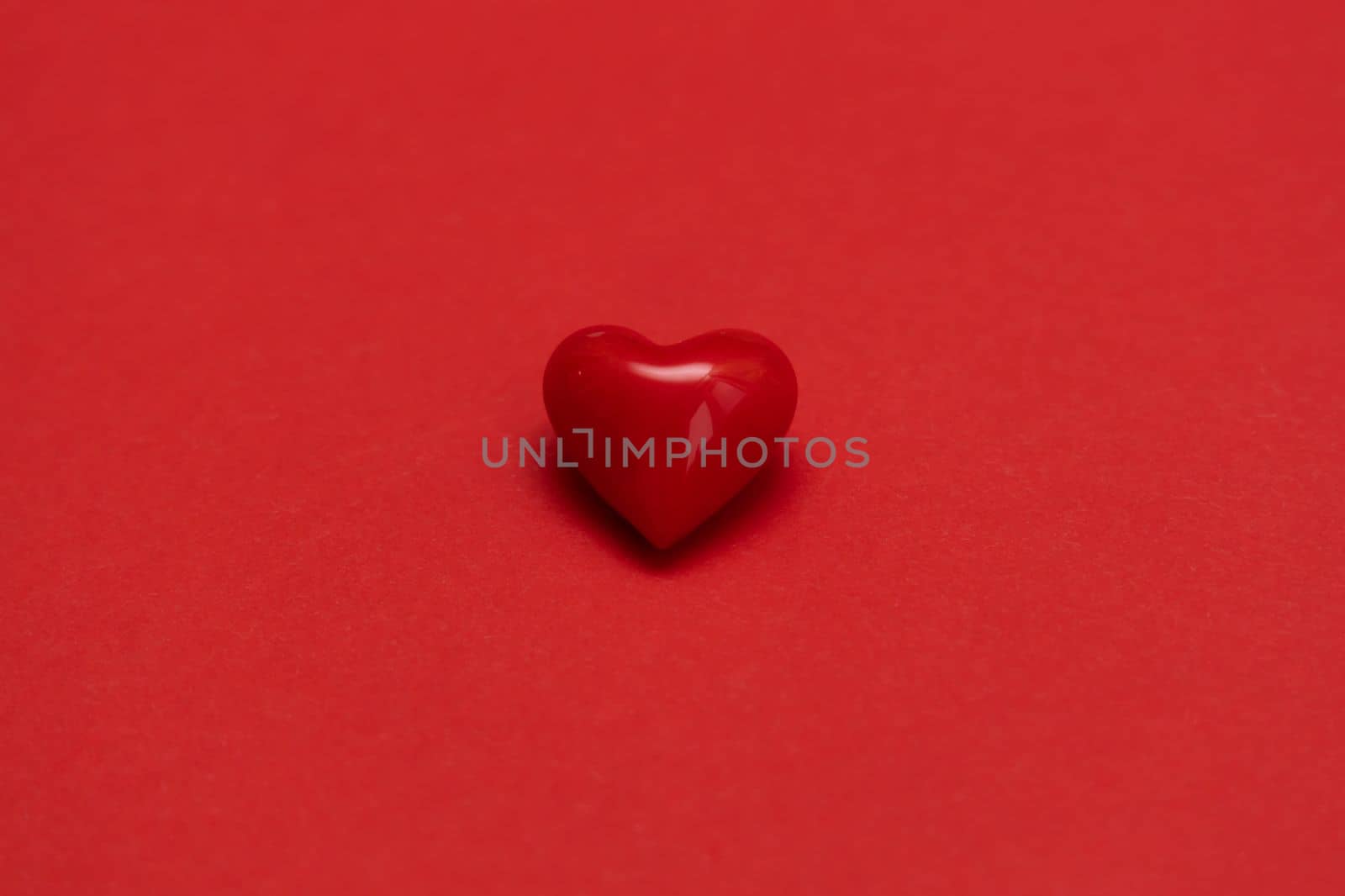 Valentines day red heart on same color background. Monochromatic vivid color. Valentine's day concept. Close up, copy space