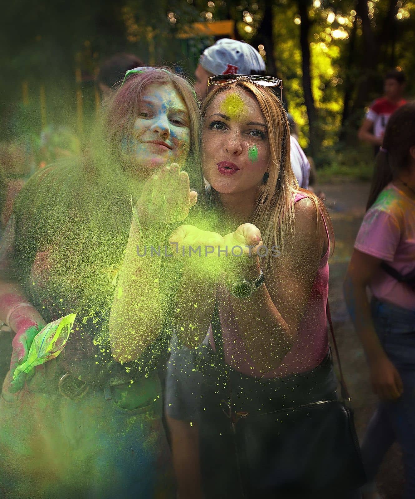 Young people, teenagers and adults celebrate the Holi event in Ukraine in Chernivtsi on March 8 in 2022. They have fun and throw paint at each other. High quality photo