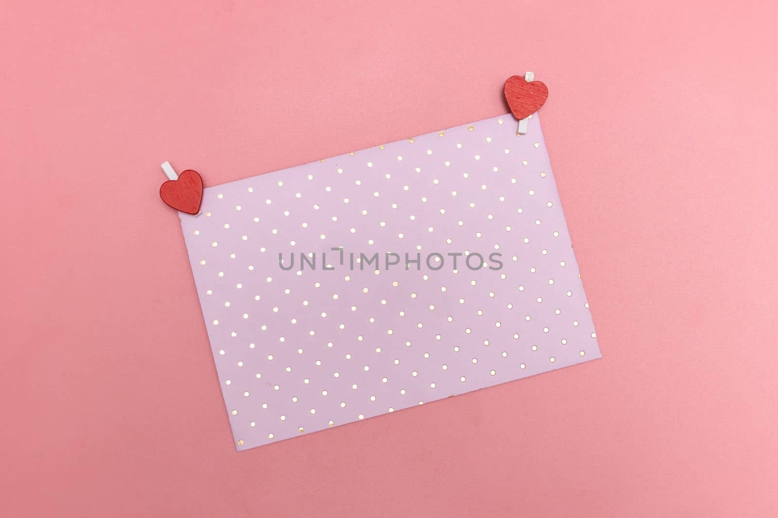 Valentines day pink envelopment on same color background. Monochromatic pastel color. Valentine's day concept. Close up, copy space. Mock up by Ri6ka