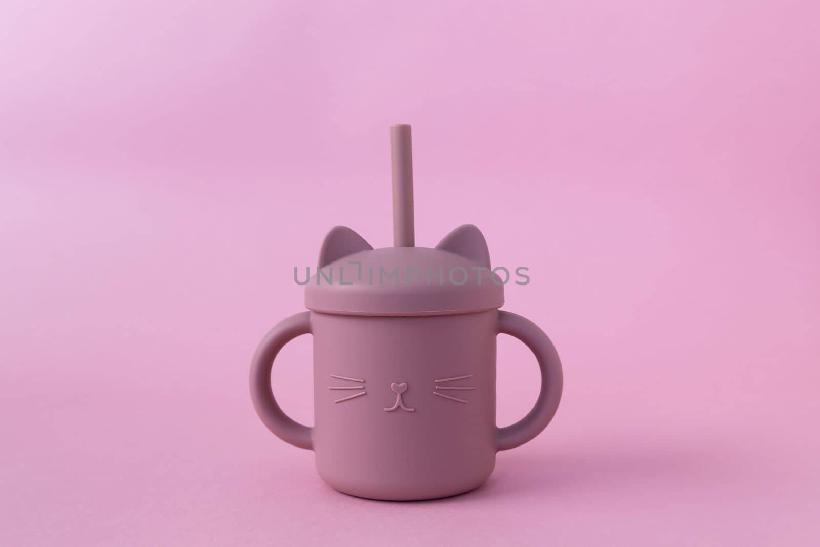 Modern pastel color silicone sippy cups with straws on pink background. Cute baby tableware, first feeding, serving concept. Funny cup. Space for text by Ri6ka