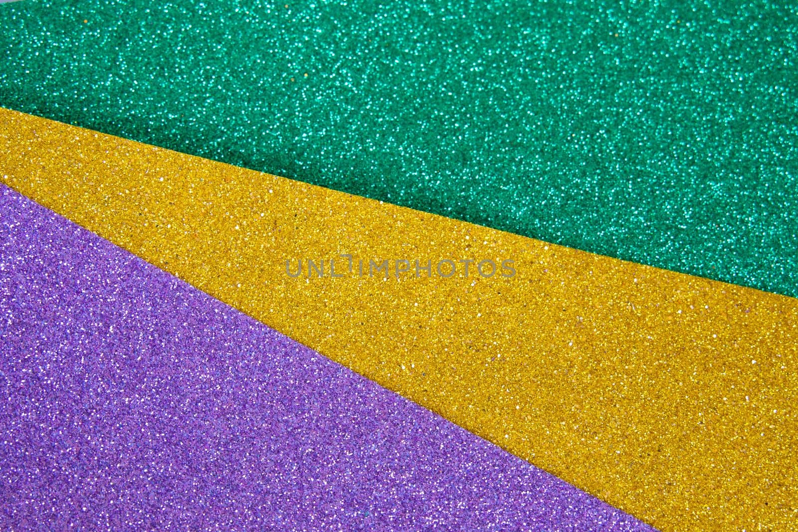 Mardi gras festive traditional color background. Abstract shiny background gold, green, purple. Glow glitter Mardi gras celebration