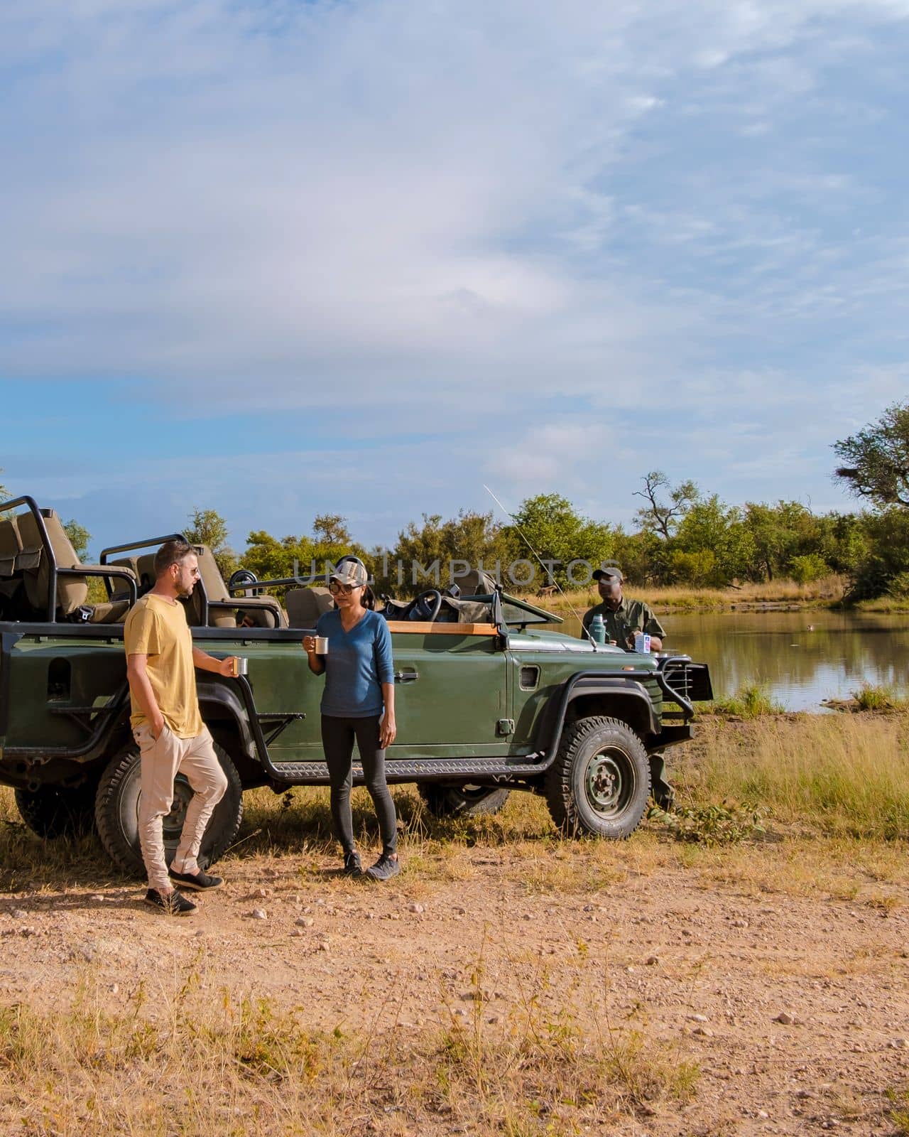 Asian women and European men on safari game drive in South Africa Kruger national park by fokkebok